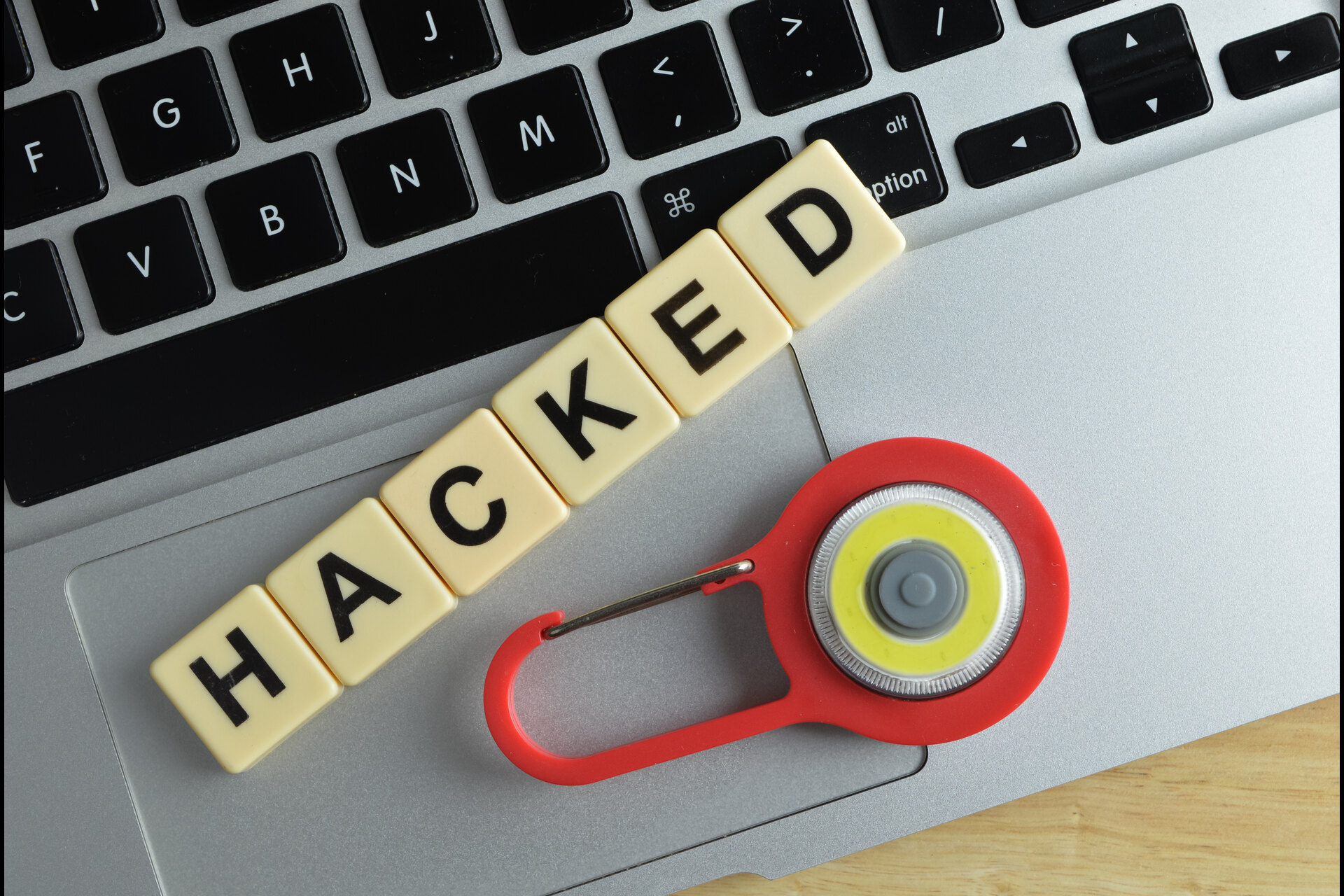 top view of toy padlock laptop and scrabble letters