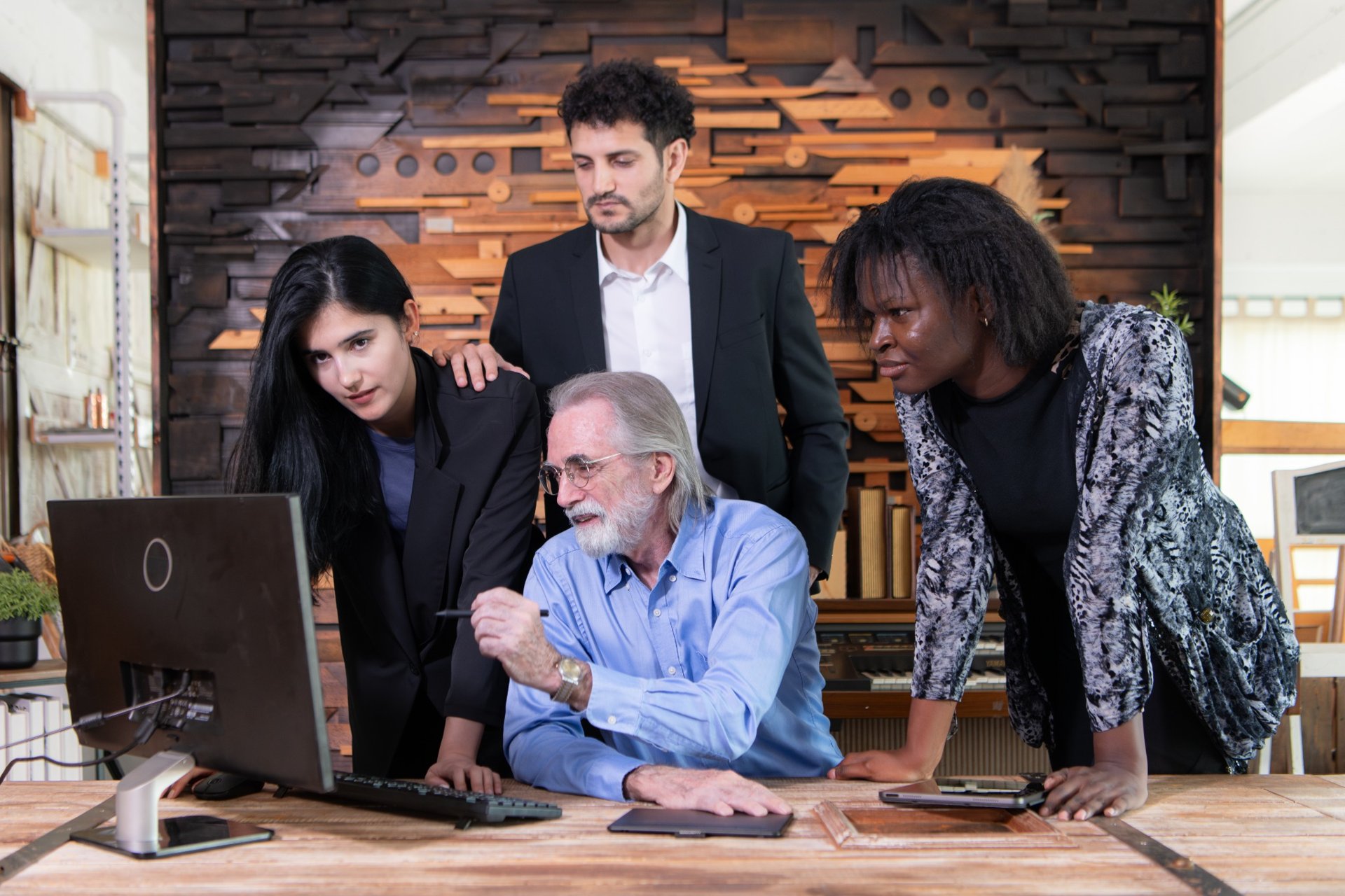 Team of professionals discussing project at office desk