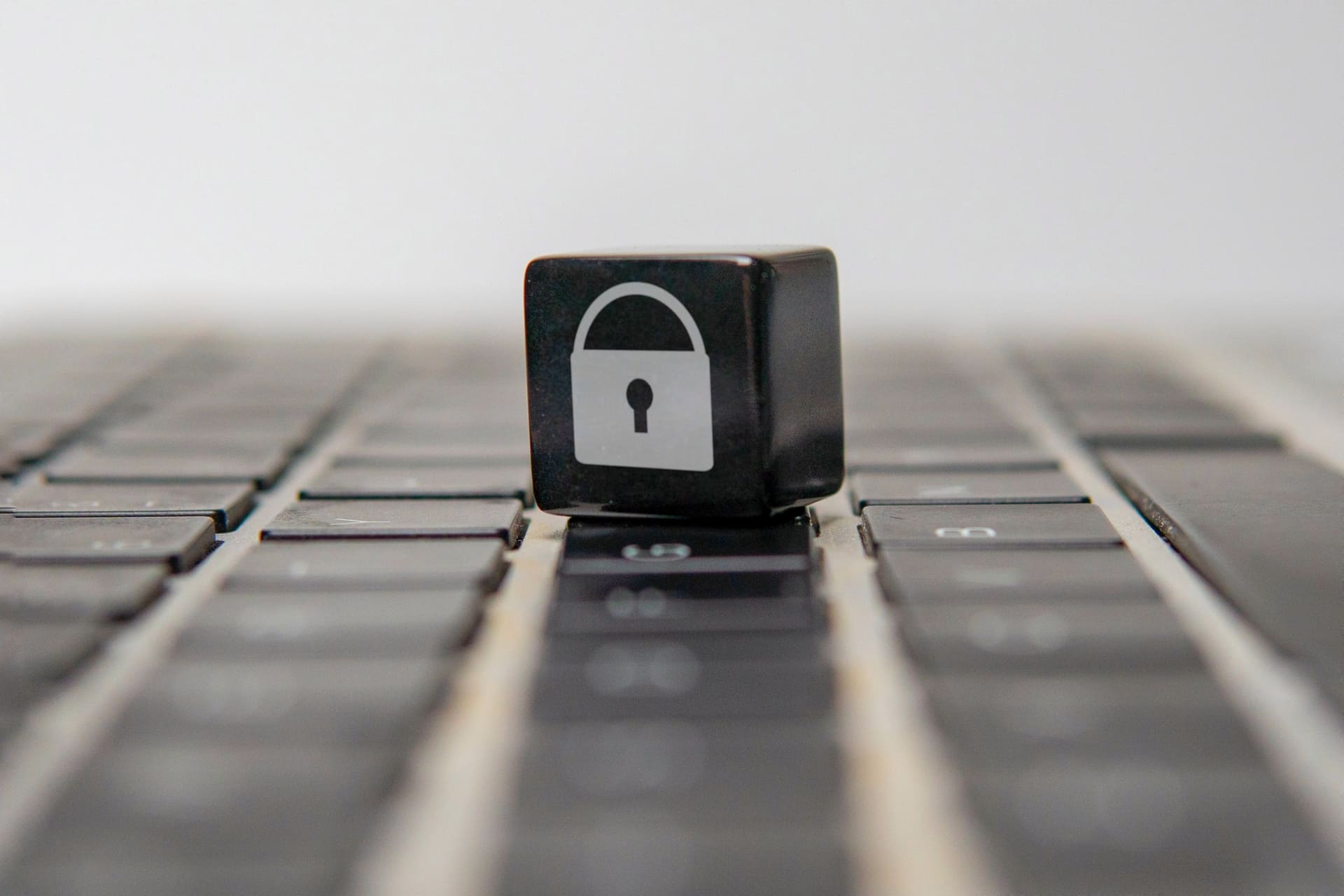 Black keyboard key with a lock icon on a laptop keyboard
