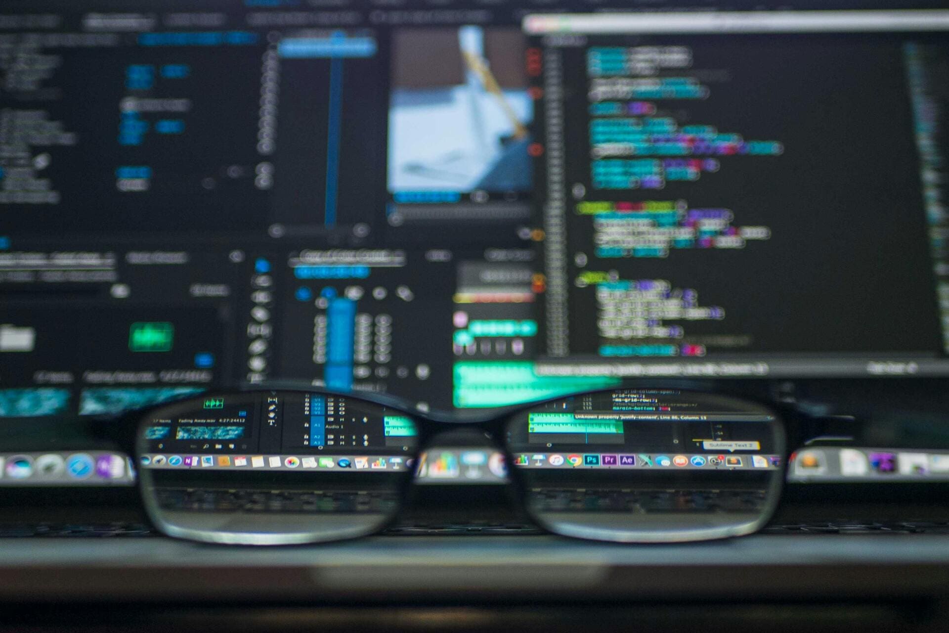Blurred screen with code viewed through eyeglasses - Cyber insurance