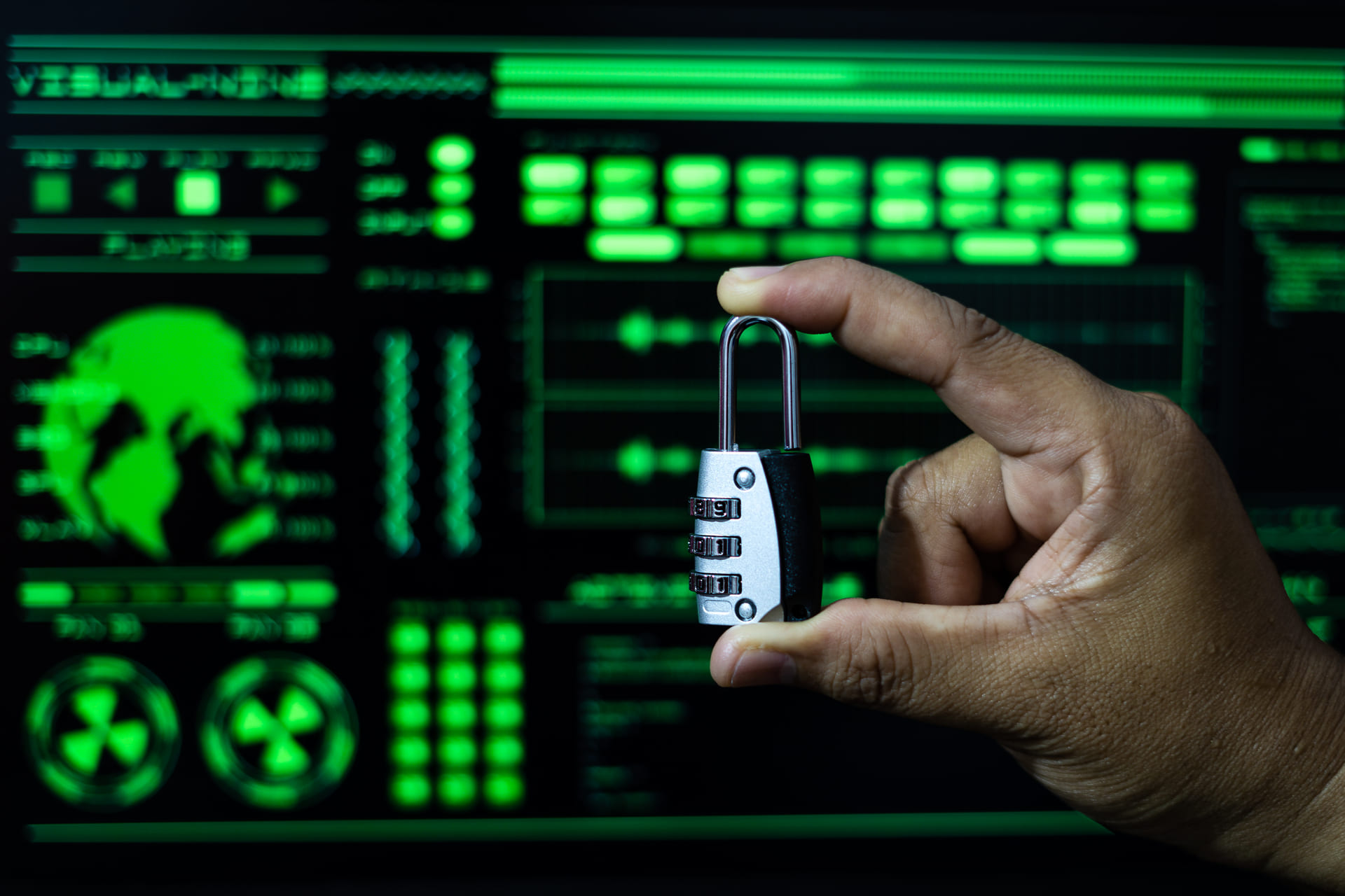 Hand holding combination padlock with digital background