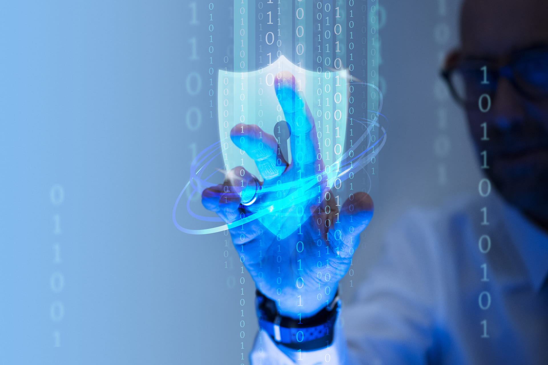 Man touching a digital security shield interface with binary code overlay
