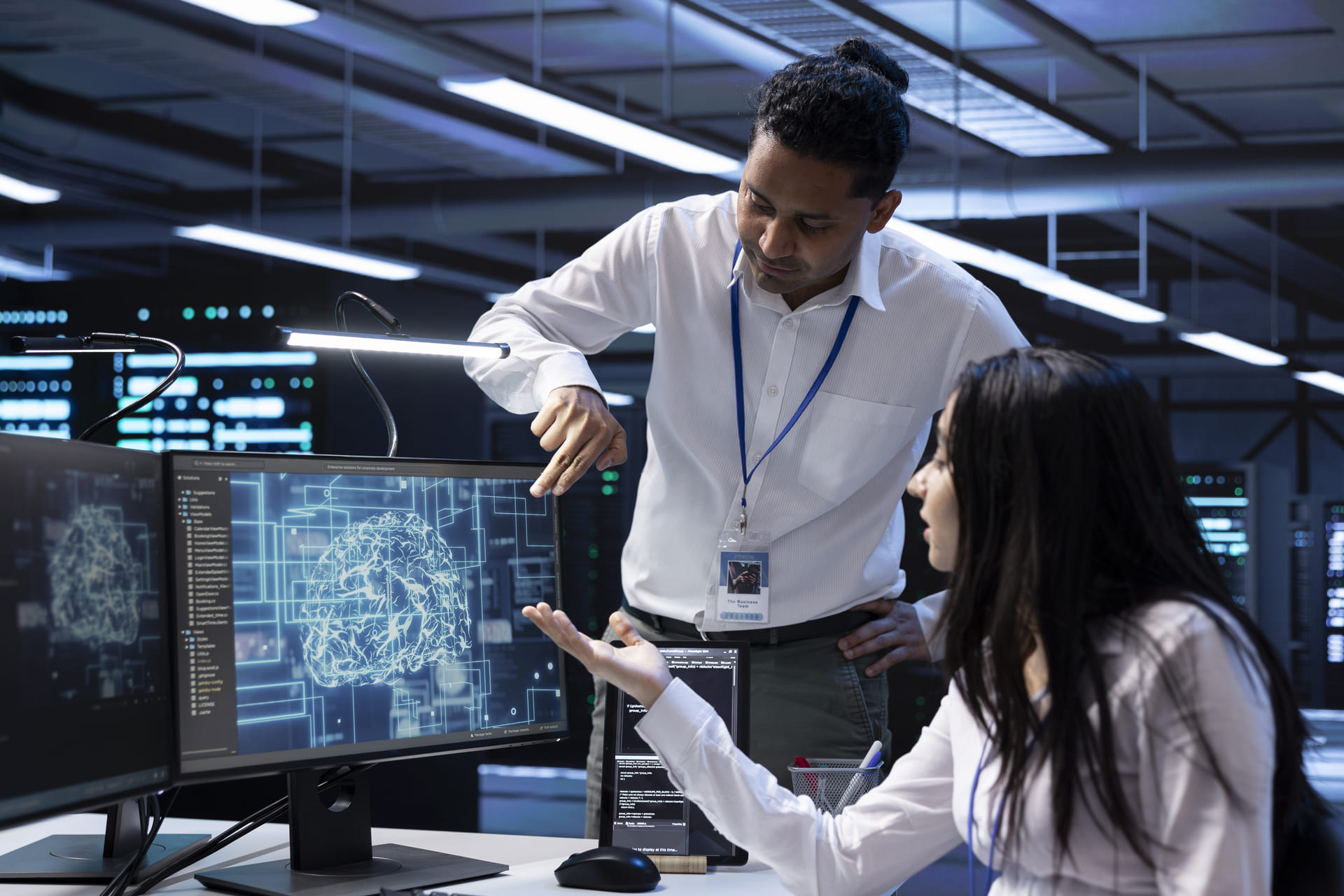 Team analyzing brain diagram on computer screen