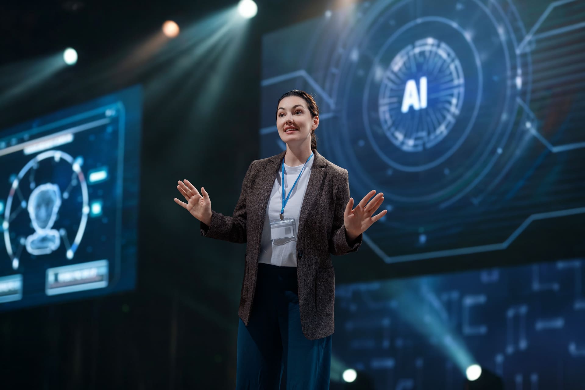 Woman presenting on stage with AI visuals on screen