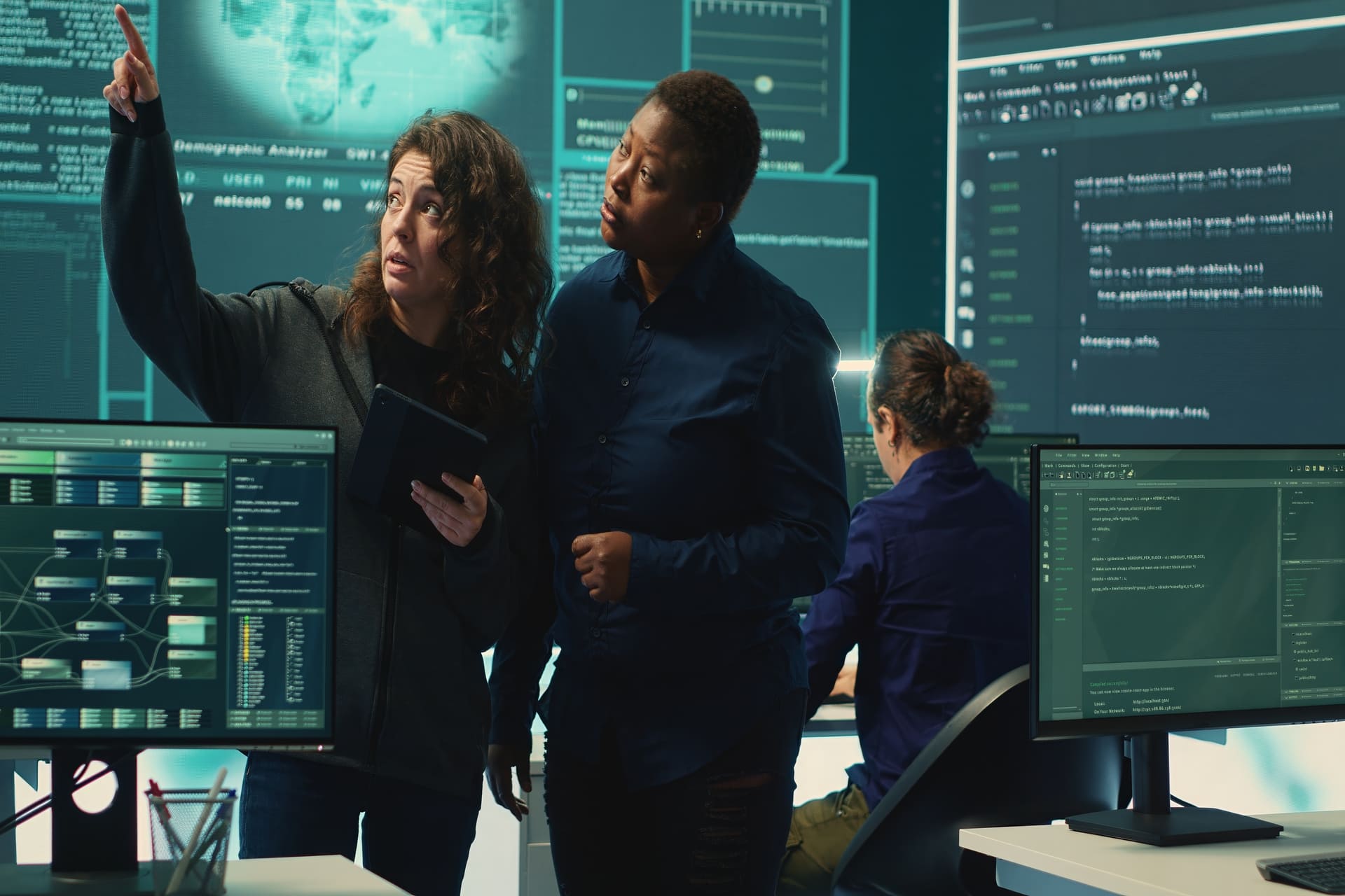 Women analyzing digital data in a cybersecurity environment