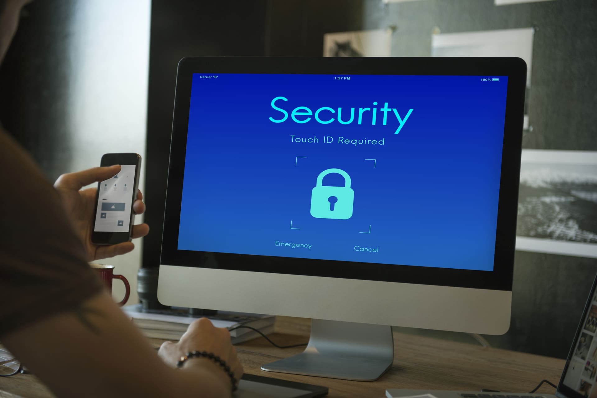 Computer monitor showing a locked security screen with Touch ID