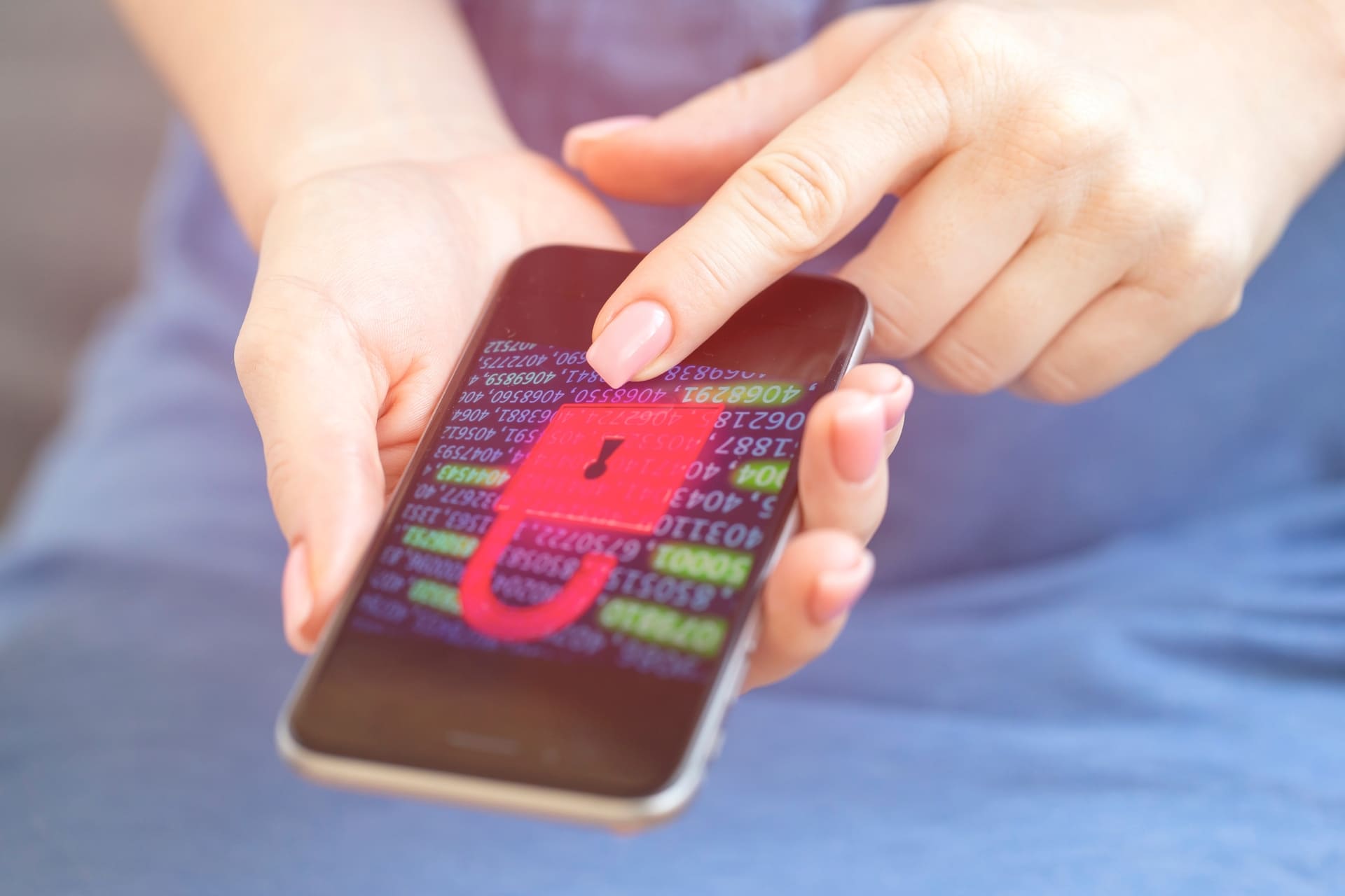 Smartphone showing a digital padlock and encrypted data on screen