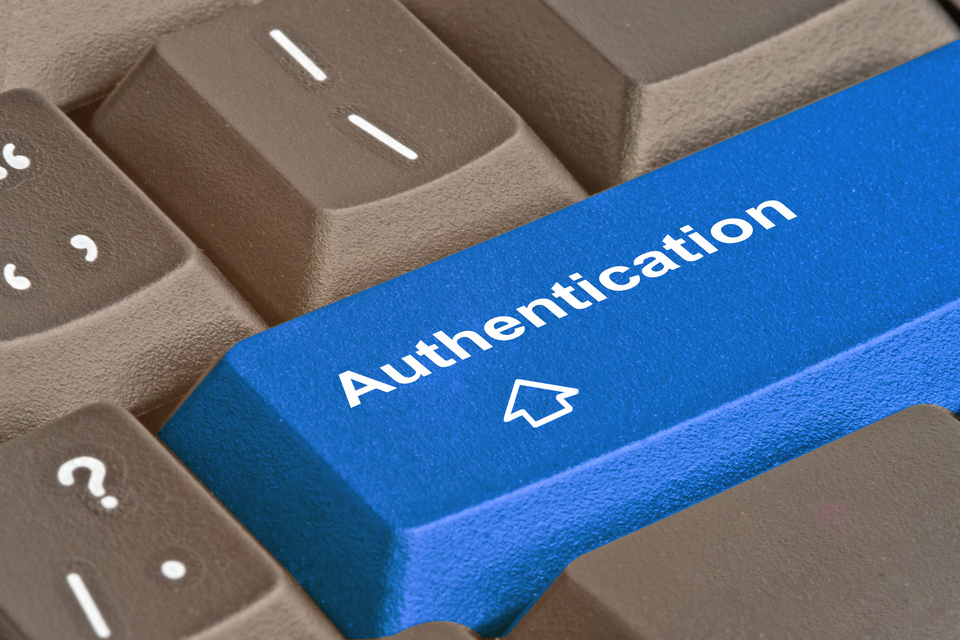 Blue keyboard key labeled authentication representing secure login