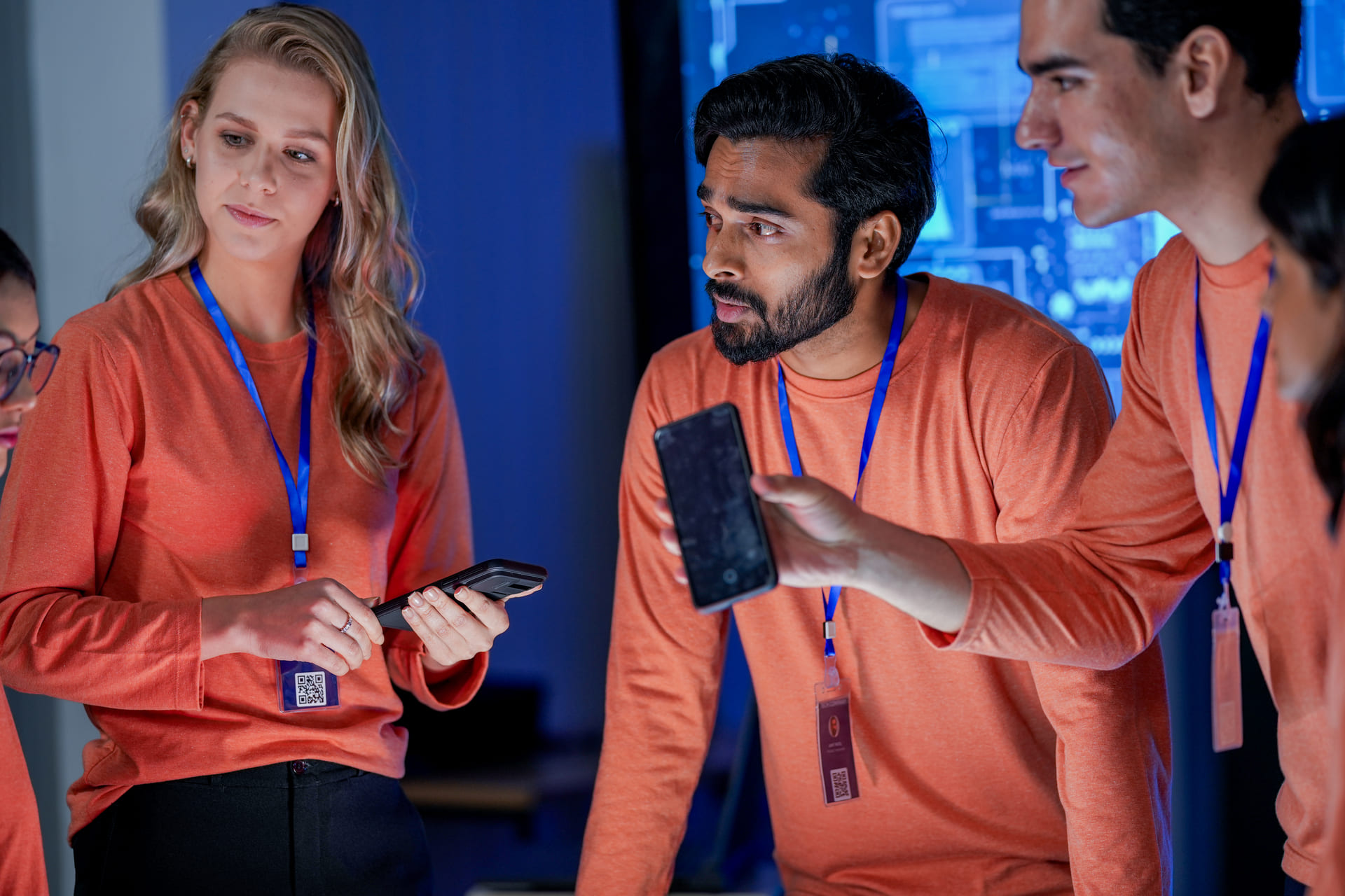 Diverse cybersecurity team discussing mobile security solutions