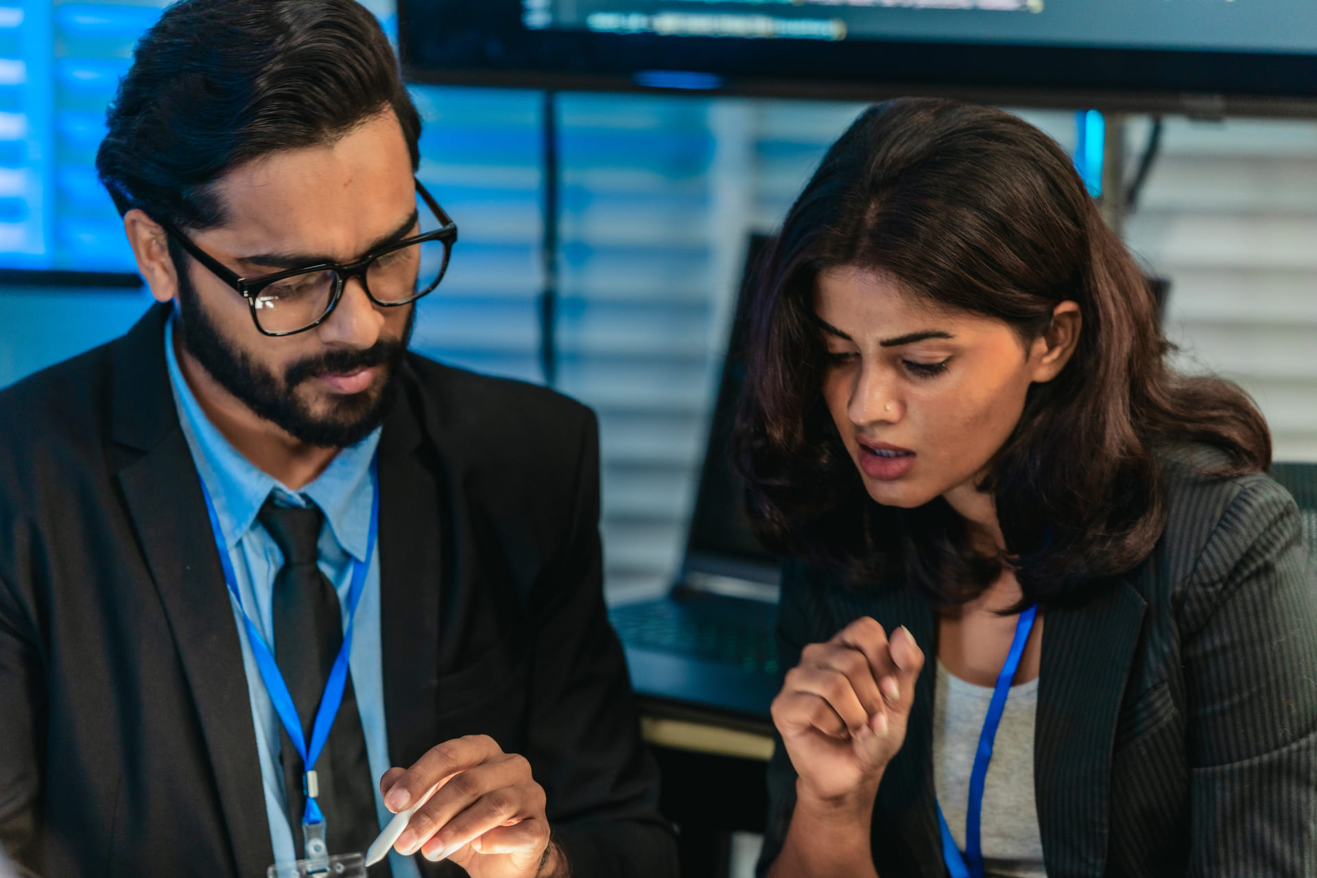 IT professionals reviewing code together in a secure operations room