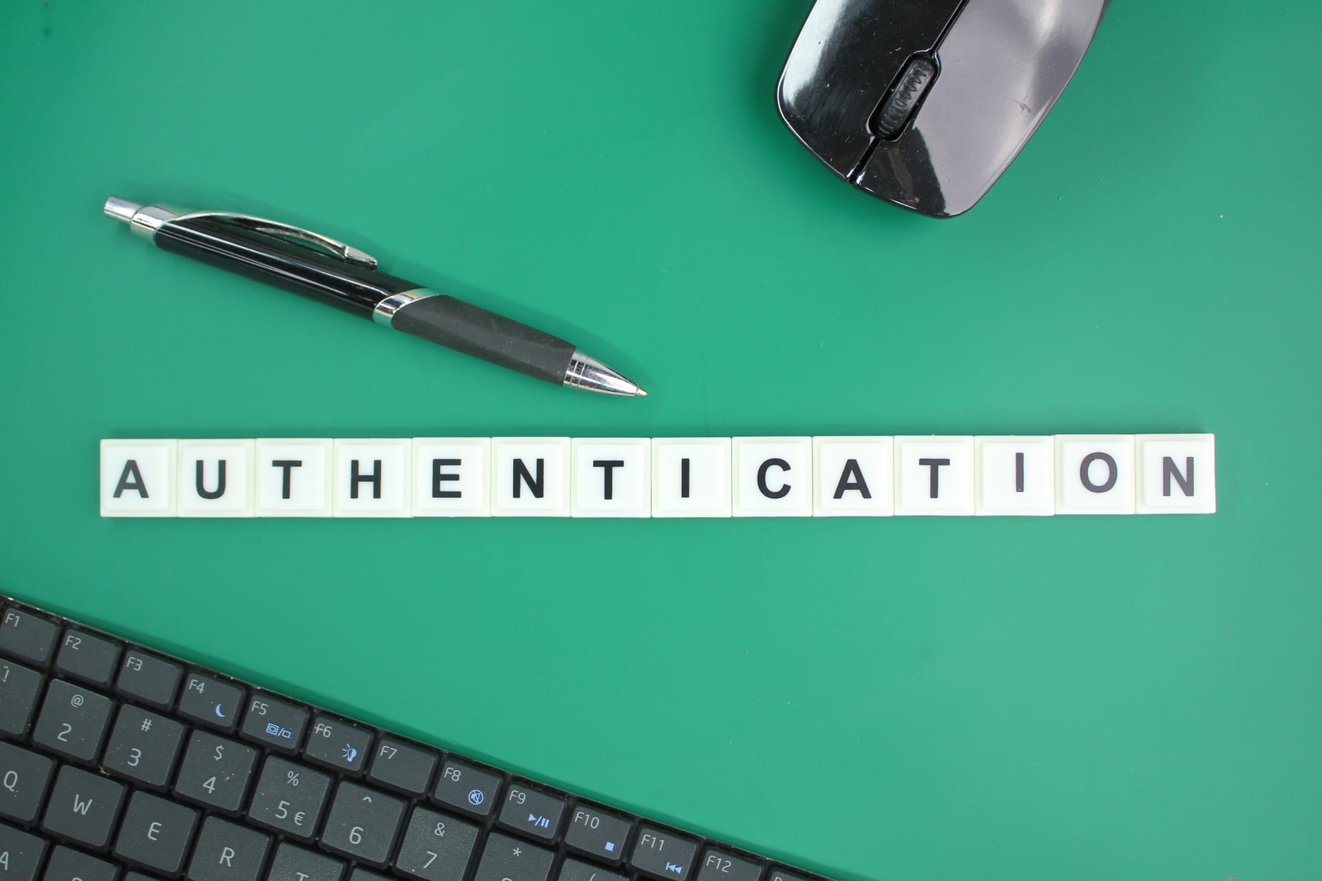 Word authentication spelled with letter tiles beside keyboard and mous | CMIT Solutions Word authentication spelled with letter tiles beside keyboard and mous