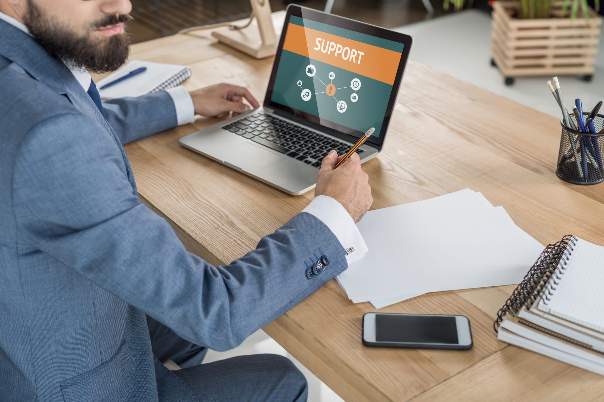 Business professional reviewing support dashboard on laptop