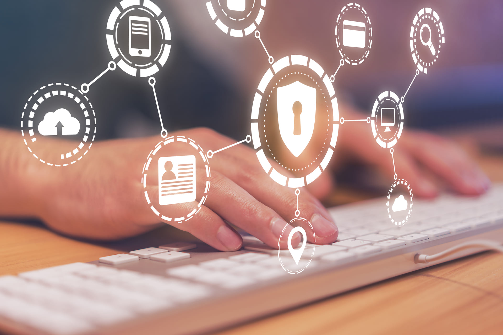 Keyboard typing with cybersecurity network icons overlay