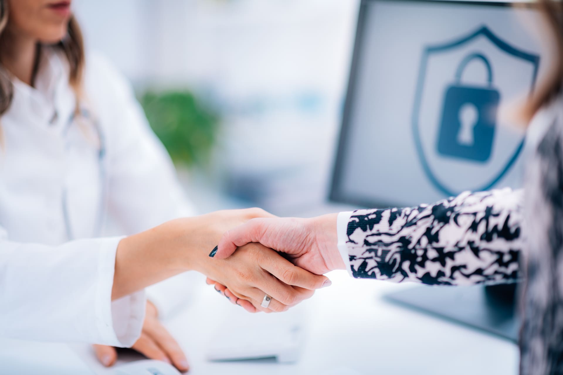 Doctor and patient shaking hands in medical office | CMIT Solutions Doctor and patient shaking hands in medical office