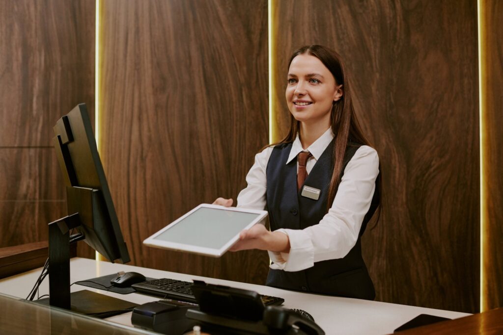 smiling-receptionist-holding-tablet