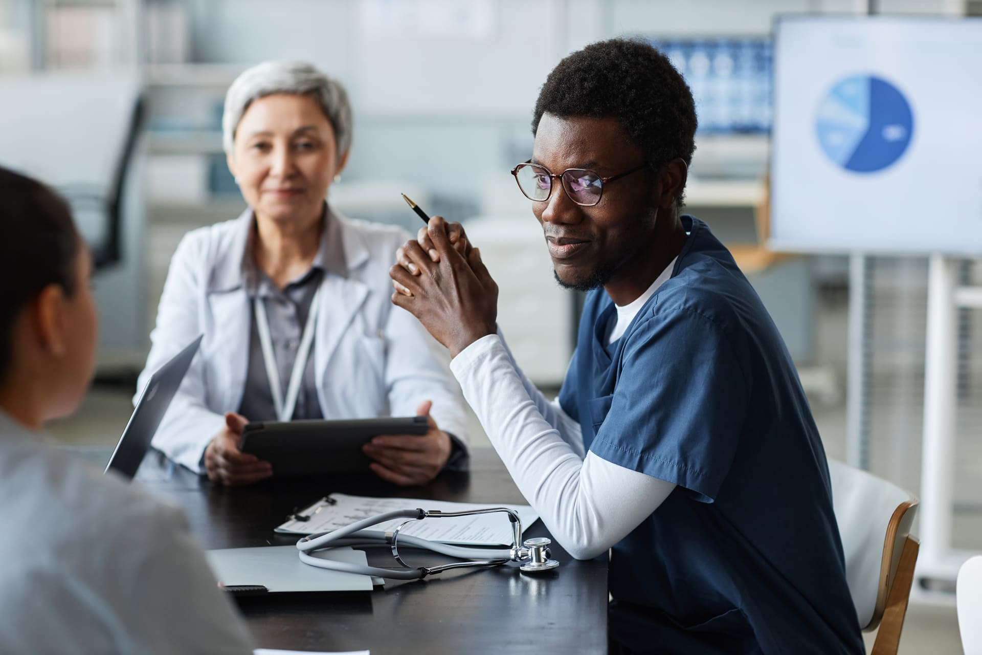 Medical professionals consulting with patient | CMIT Solutions Medical professionals consulting with patient