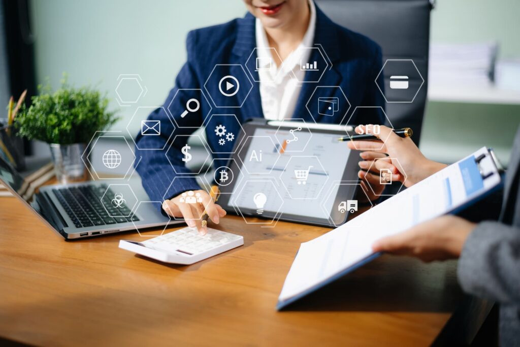 Business professionals using digital tools with overlay icons representing tech and analytics