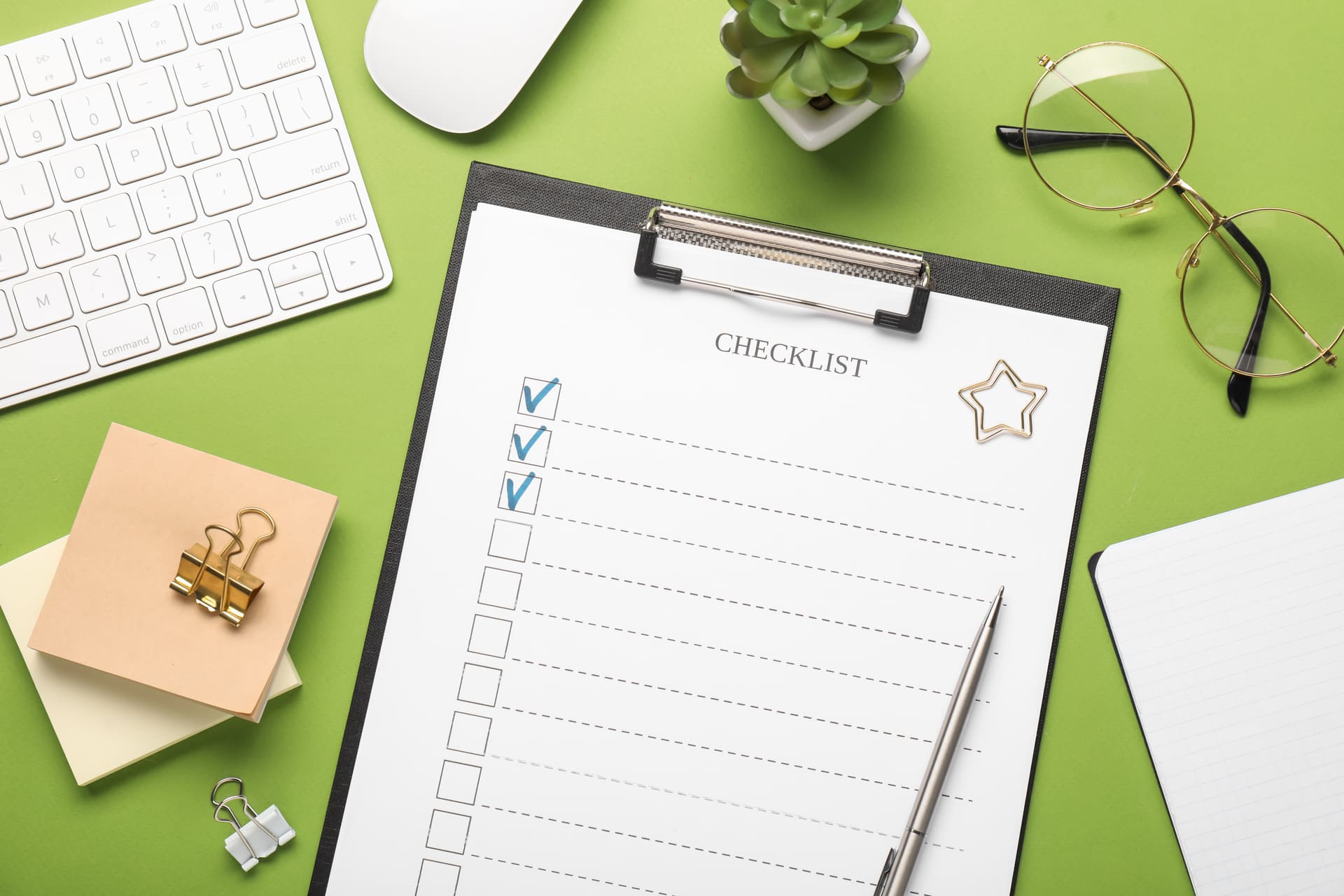 flat-lay-composition-with-checklist-on-green-background | CMIT Solutions flat-lay-composition-with-checklist-on-green-background