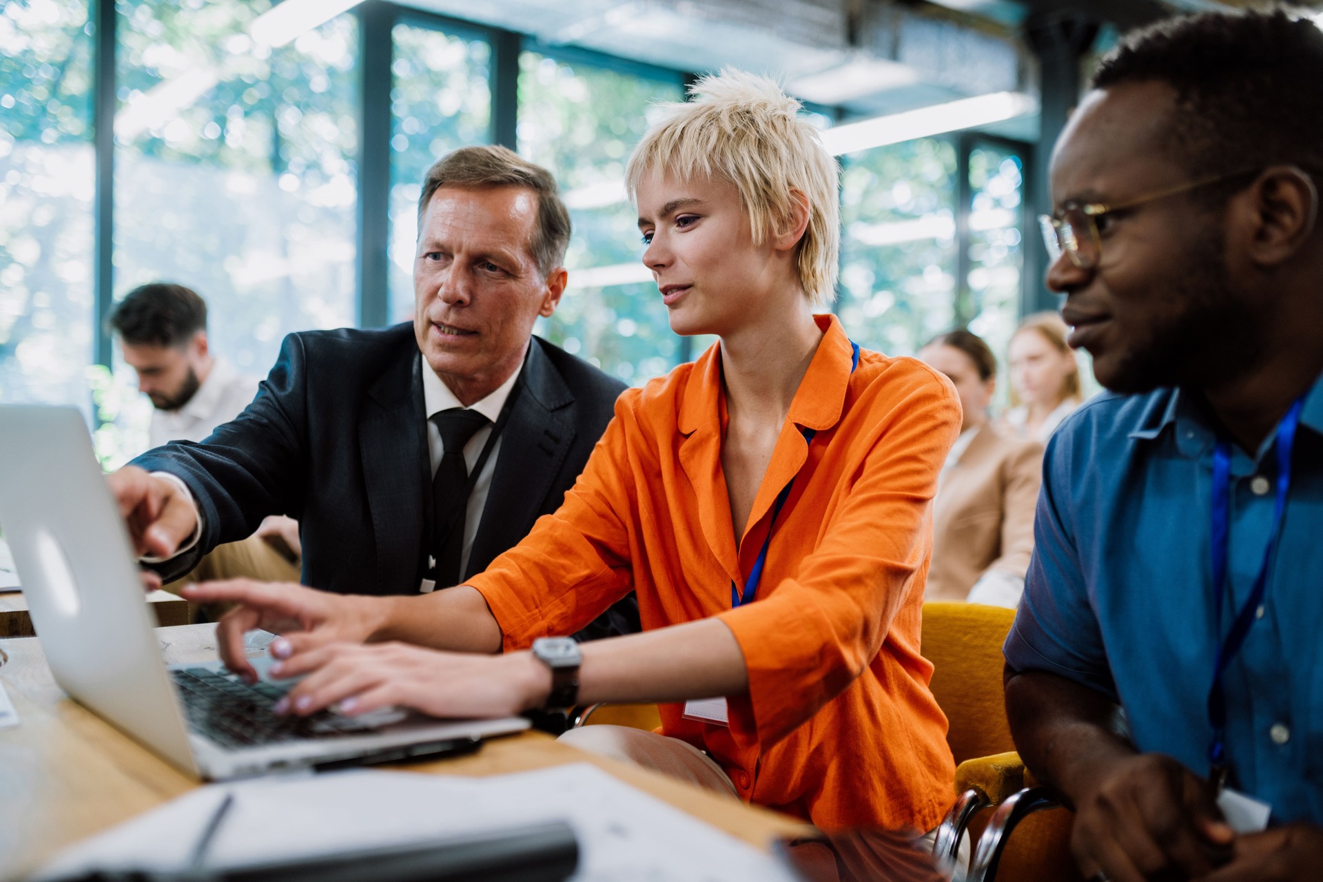 Business professionals discussing a project on a laptop | CMIT Solutions Business professionals discussing a project on a laptop