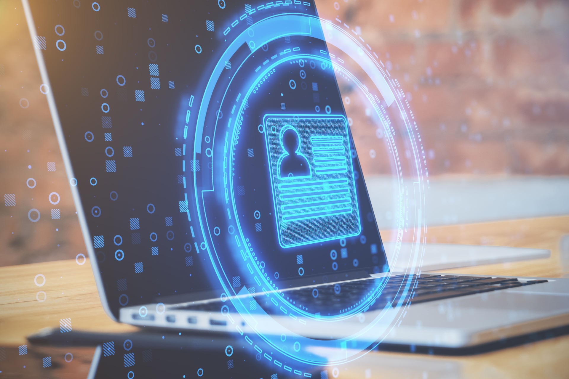 Laptop with glowing digital identity security interface | CMIT Solutions Laptop with glowing digital identity security interface