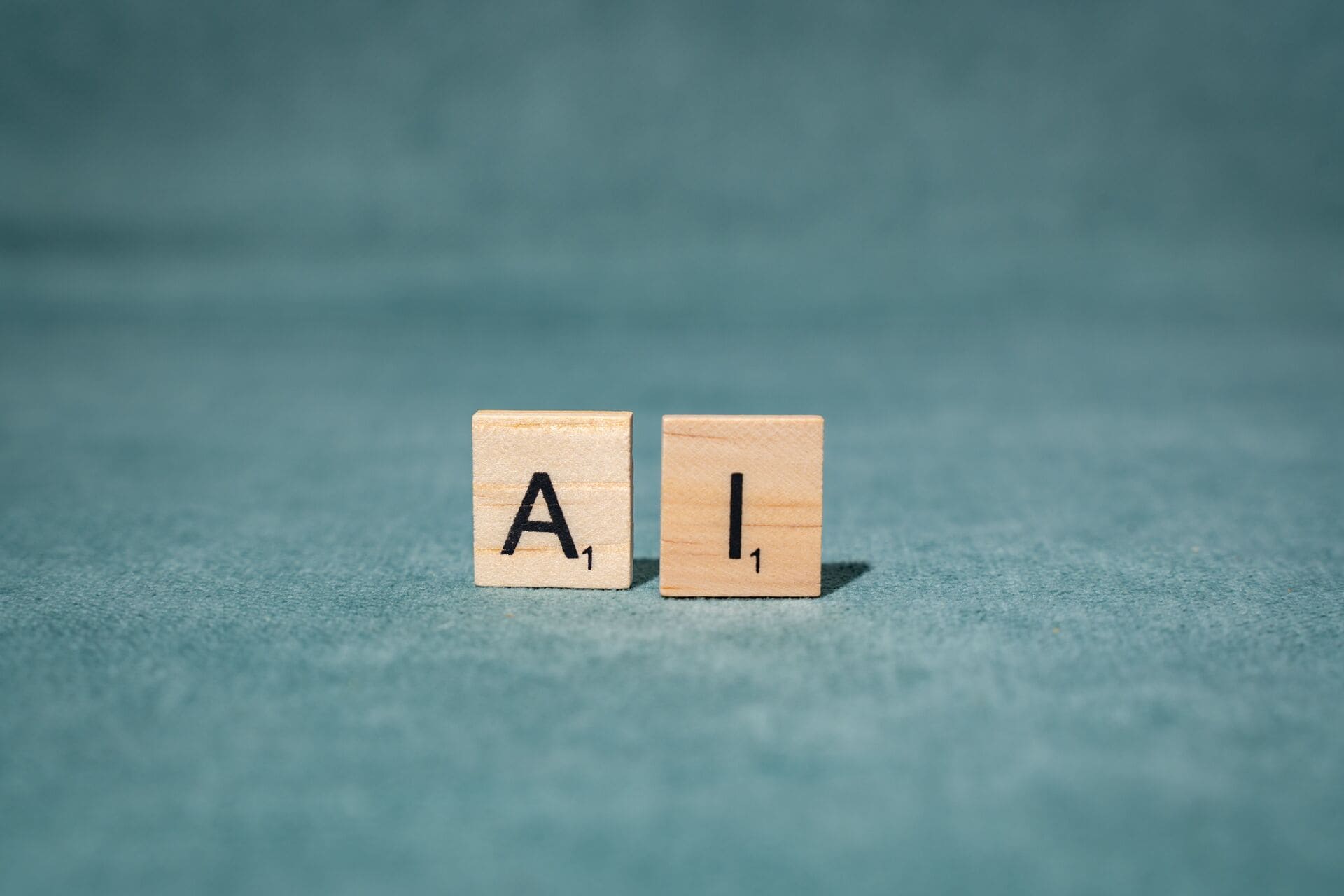 ai-wooden-letter-tiles-on-green-background | CMIT Solutions ai-wooden-letter-tiles-on-green-background