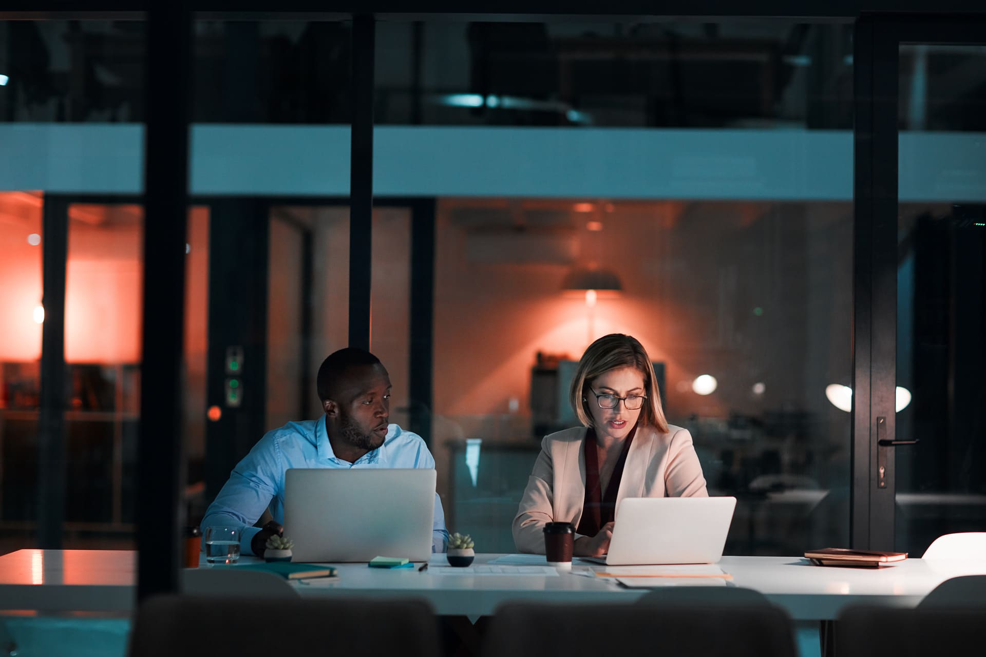 colleagues-working-late-using-laptops-at-office | CMIT Solutions colleagues-working-late-using-laptops-at-office
