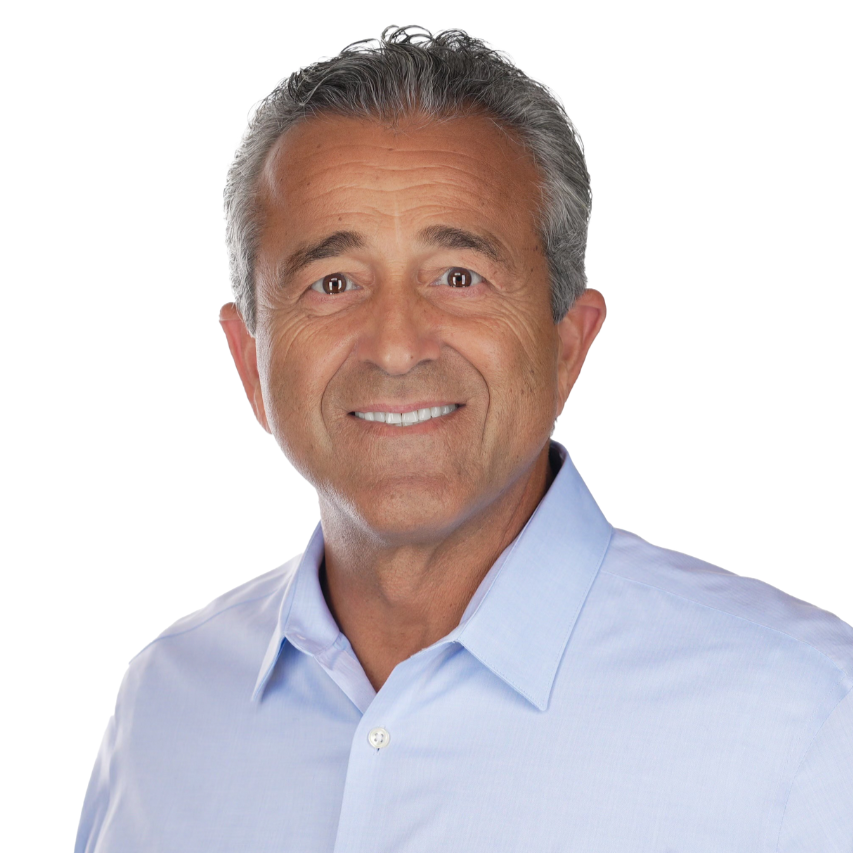 Smiling middle-aged man in a light blue dress shirt looking at the camera, white background