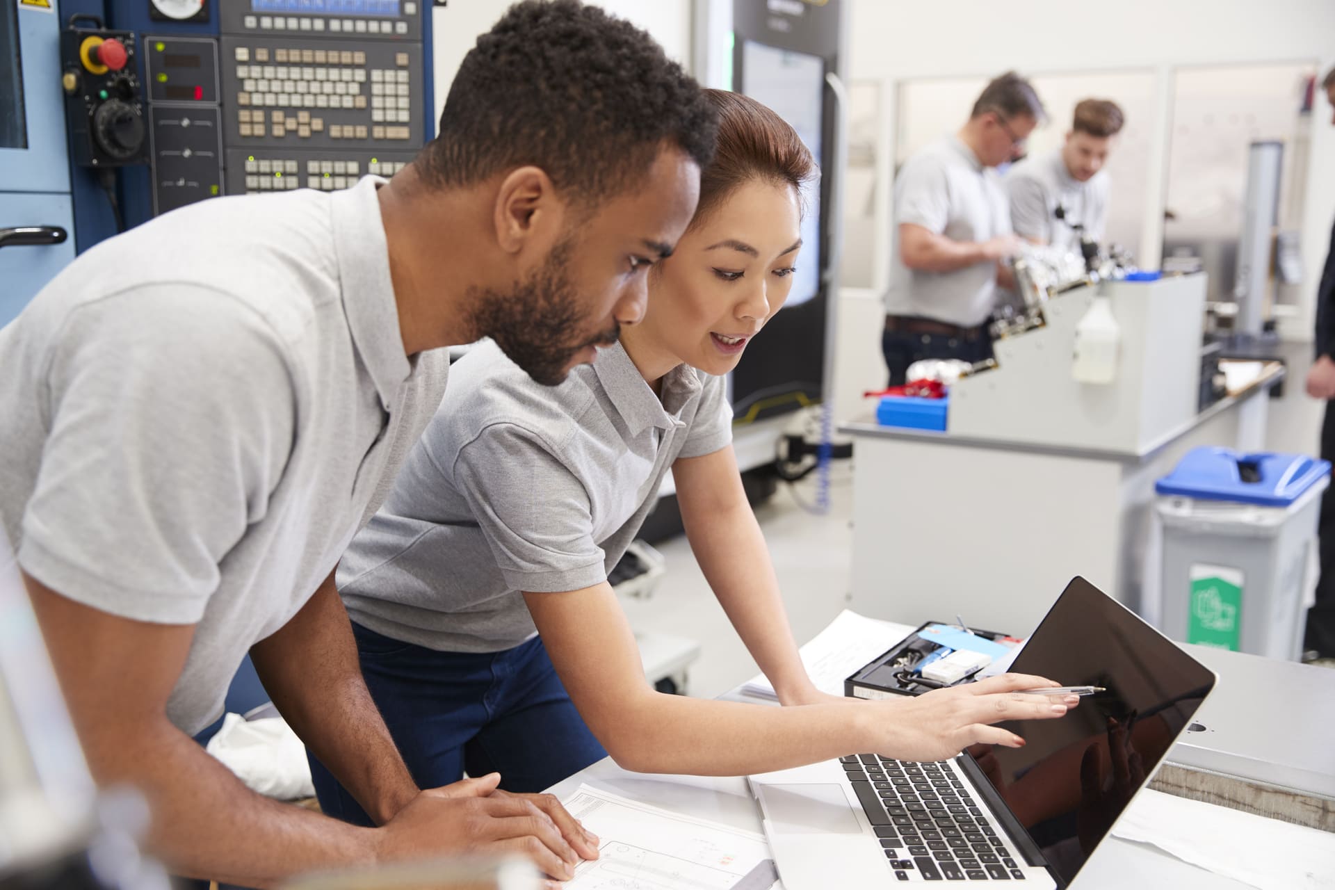 man-and-woman-working-on-laptop-in-workplace