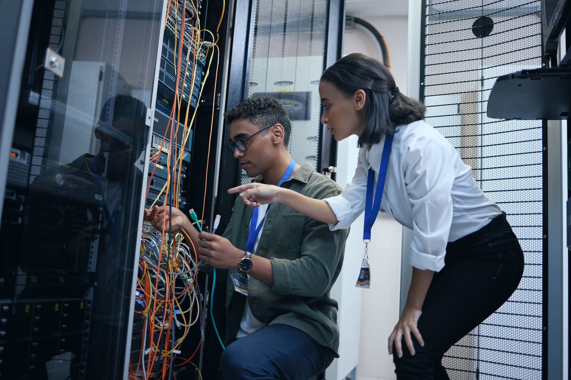 technicians-working-with-cables-in-server-room | CMIT Solutions technicians-working-with-cables-in-server-room