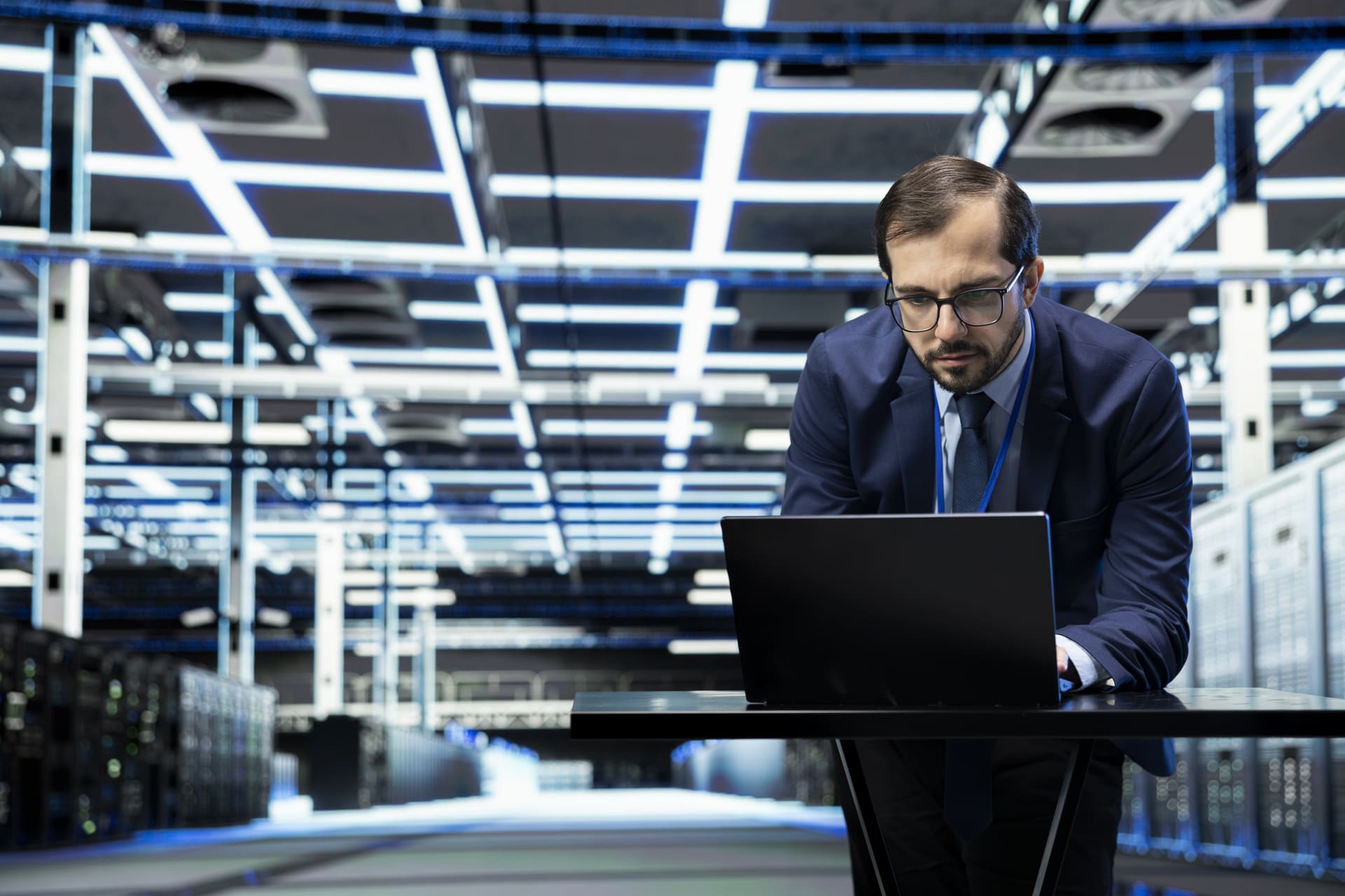 data-center-technician-at-desk-using-laptop | CMIT Solutions data-center-technician-at-desk-using-laptop