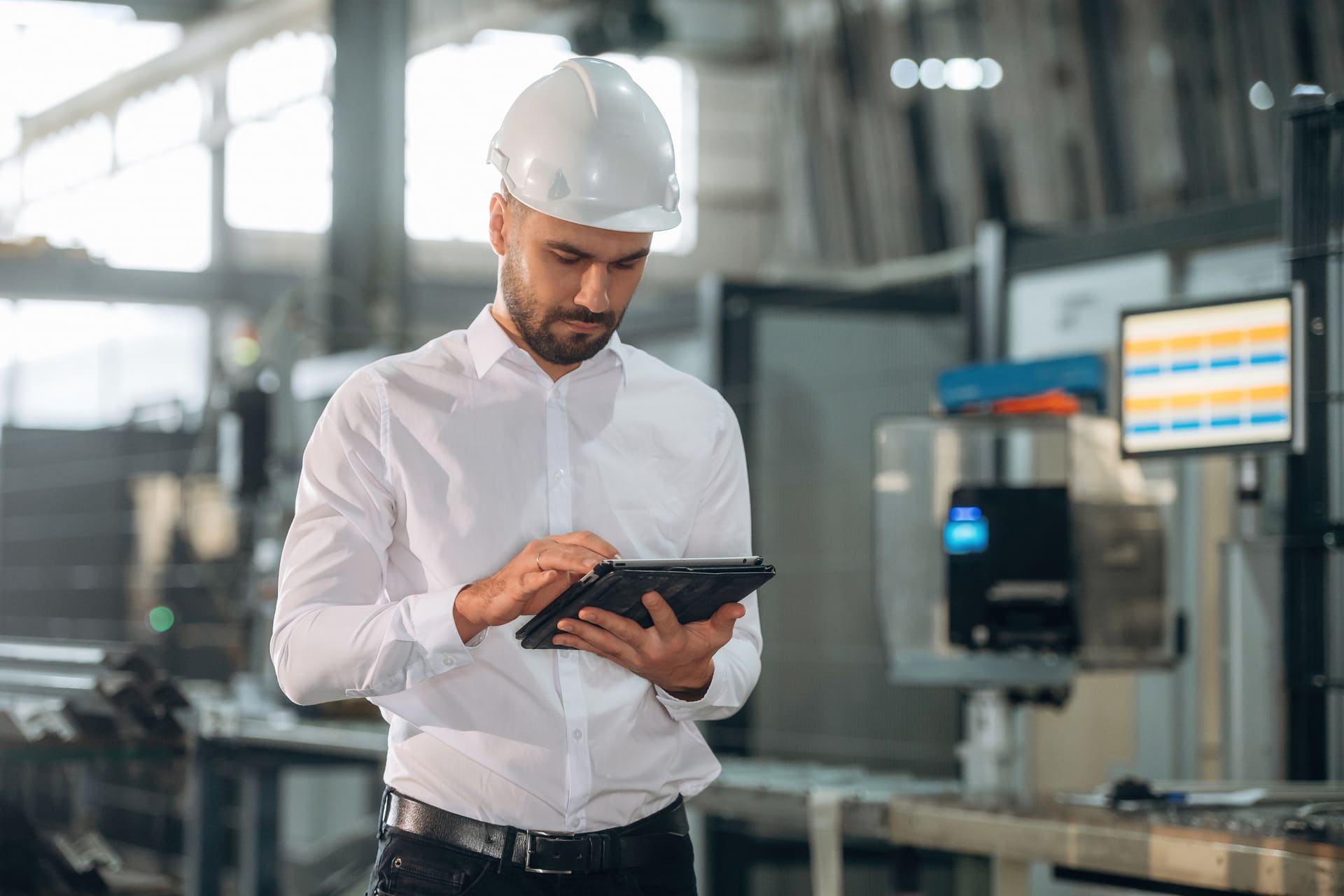 front-view-standing-man-is-working-in-the-modern-factory | CMIT Solutions front-view-standing-man-is-working-in-the-modern-factory