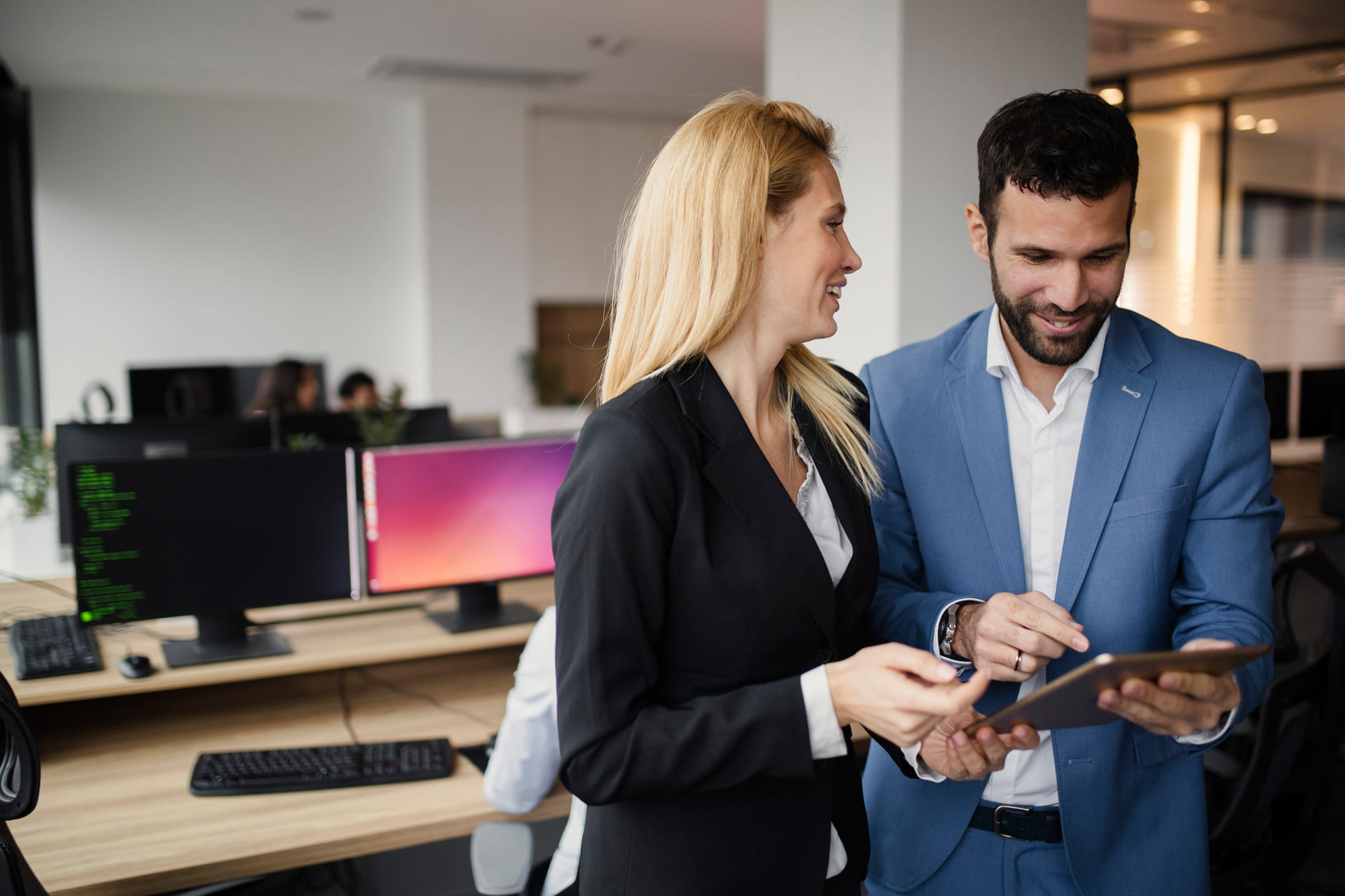 business-colleagues-discussing-work-on-a-tablet-desk | CMIT Solutions business-colleagues-discussing-work-on-a-tablet-desk