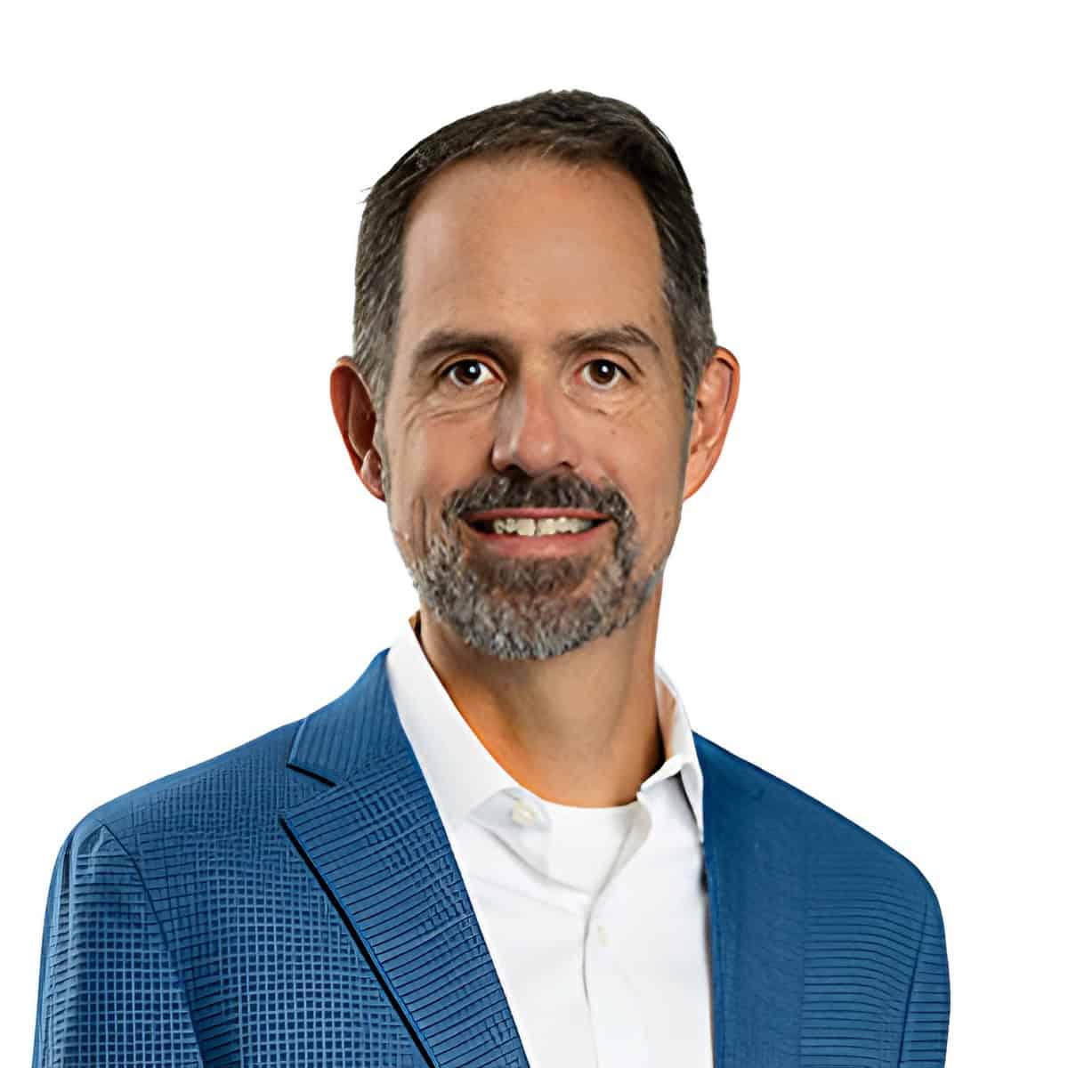 Portrait of a smiling man with short dark hair and a gray beard, wearing a blue blazer and white shirt.