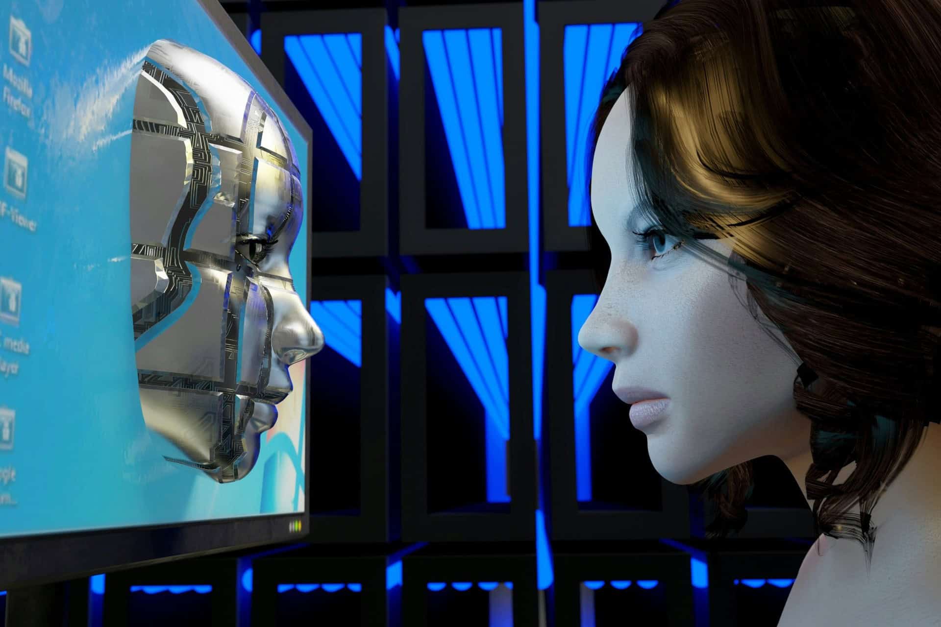 ai-human-machine-interaction | CMIT Solutions Woman interacting with a humanoid robot displayed on a computer screen, illustrating artificial intelligence and human-machine interaction.