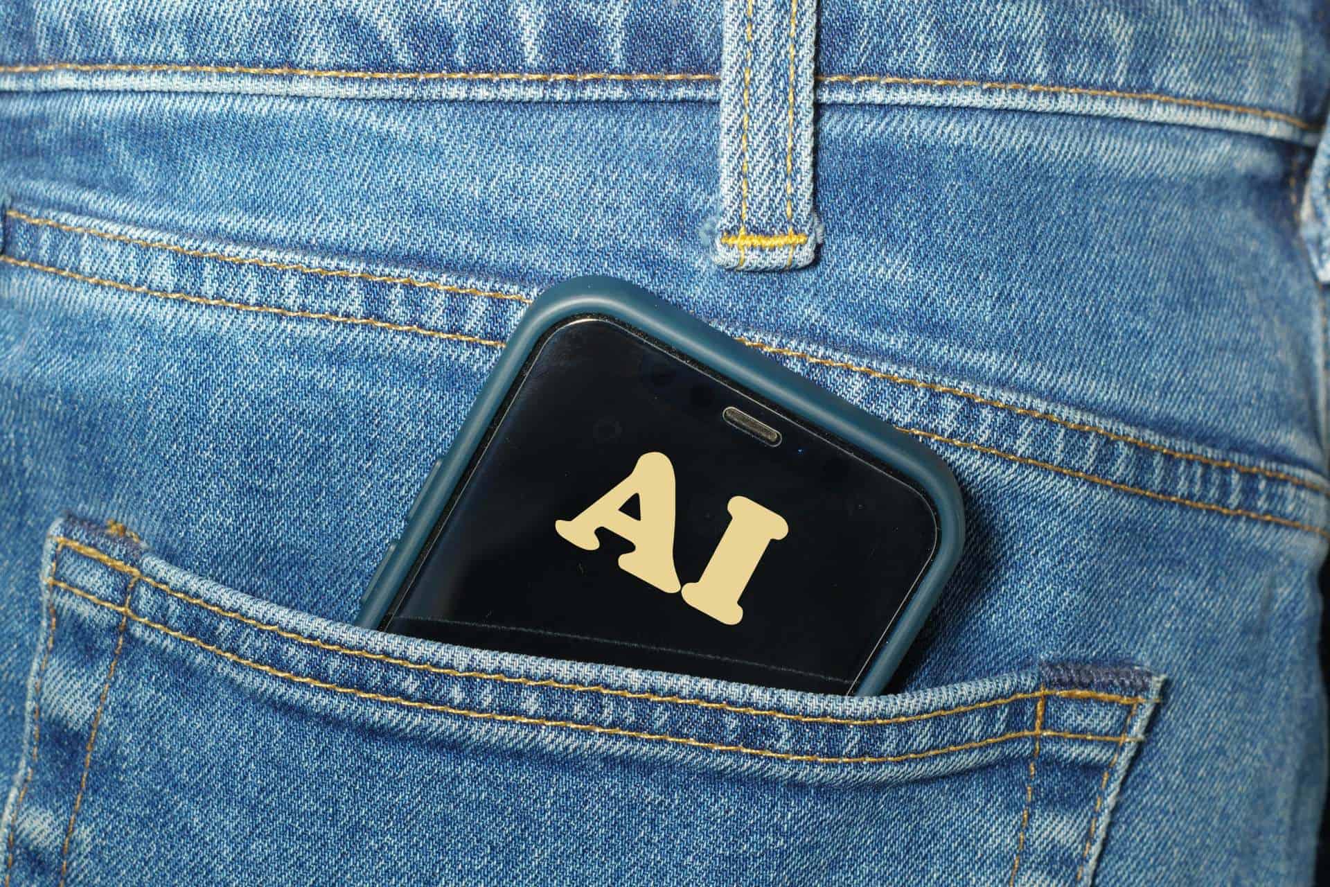 artificial-intelligence-ai-smartphone | CMIT Solutions Smartphone displaying AI lettering in the back pocket of blue denim jeans.