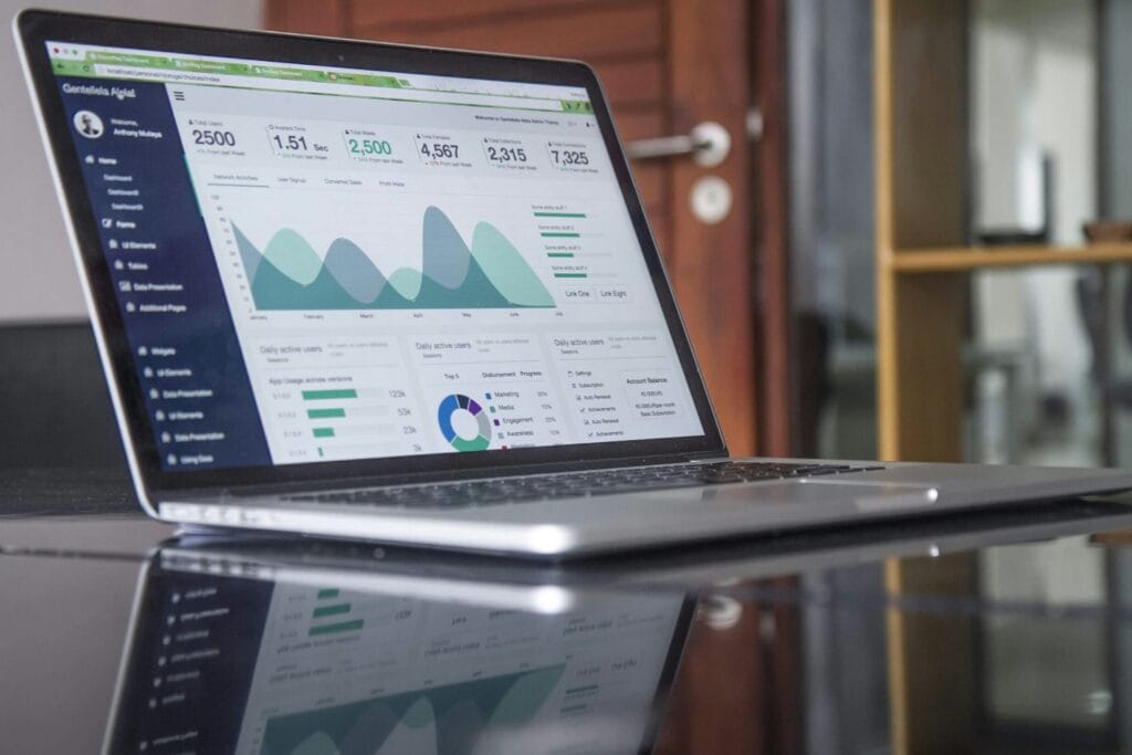 Laptop displaying business analytics dashboard with performance charts and statistics.