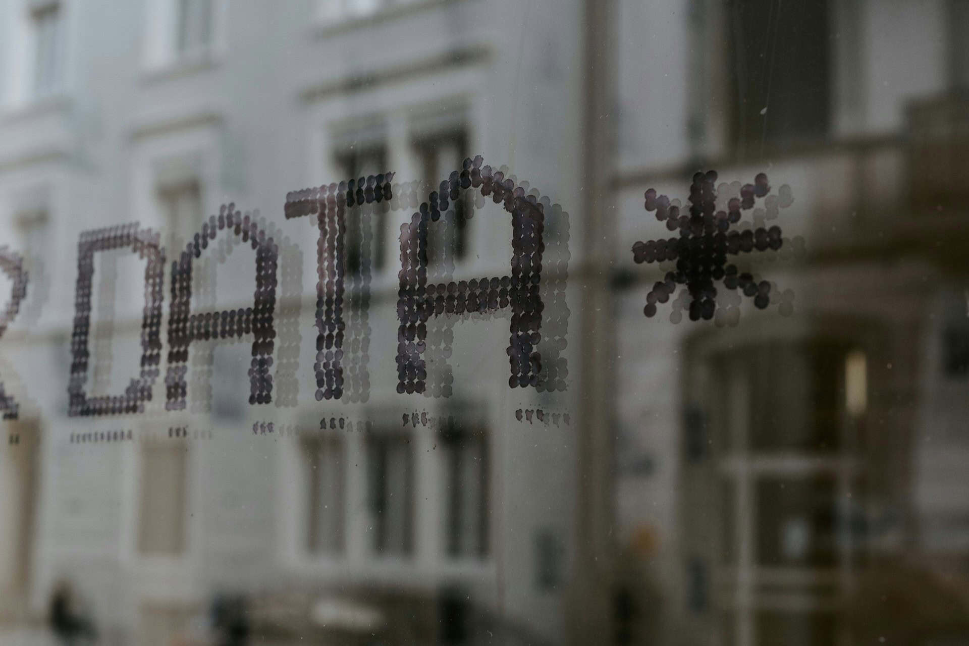 claudio-schwarz-fyeOxvYvIyY-unsplash 1 | CMIT Solutions The word DATA and an asterisk displayed on a glass window, representing data analytics and digital technology.
